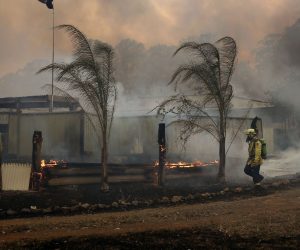 epa07990017 Firefighters work to save a house at Possum Brush near Taree, New South Wales, Australia, 12 November 2019. At least 60 fires are burning across New South Wales, with a fire front of approximately 1,000 kilometers. According to media reports, 200 properties in New South Wales and Queensland have been destroyed since 08 November.  EPA/DARREN PATEMAN AUSTRALIA AND NEW ZEALAND OUT