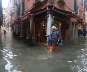 epa07990604 People wade through floodwaters in Venice, Italy, 12 November 2019. The high tide has already reached the level of 1 meter above sea level in Venice at 8 am.  EPA/ANDREA MEROLA
