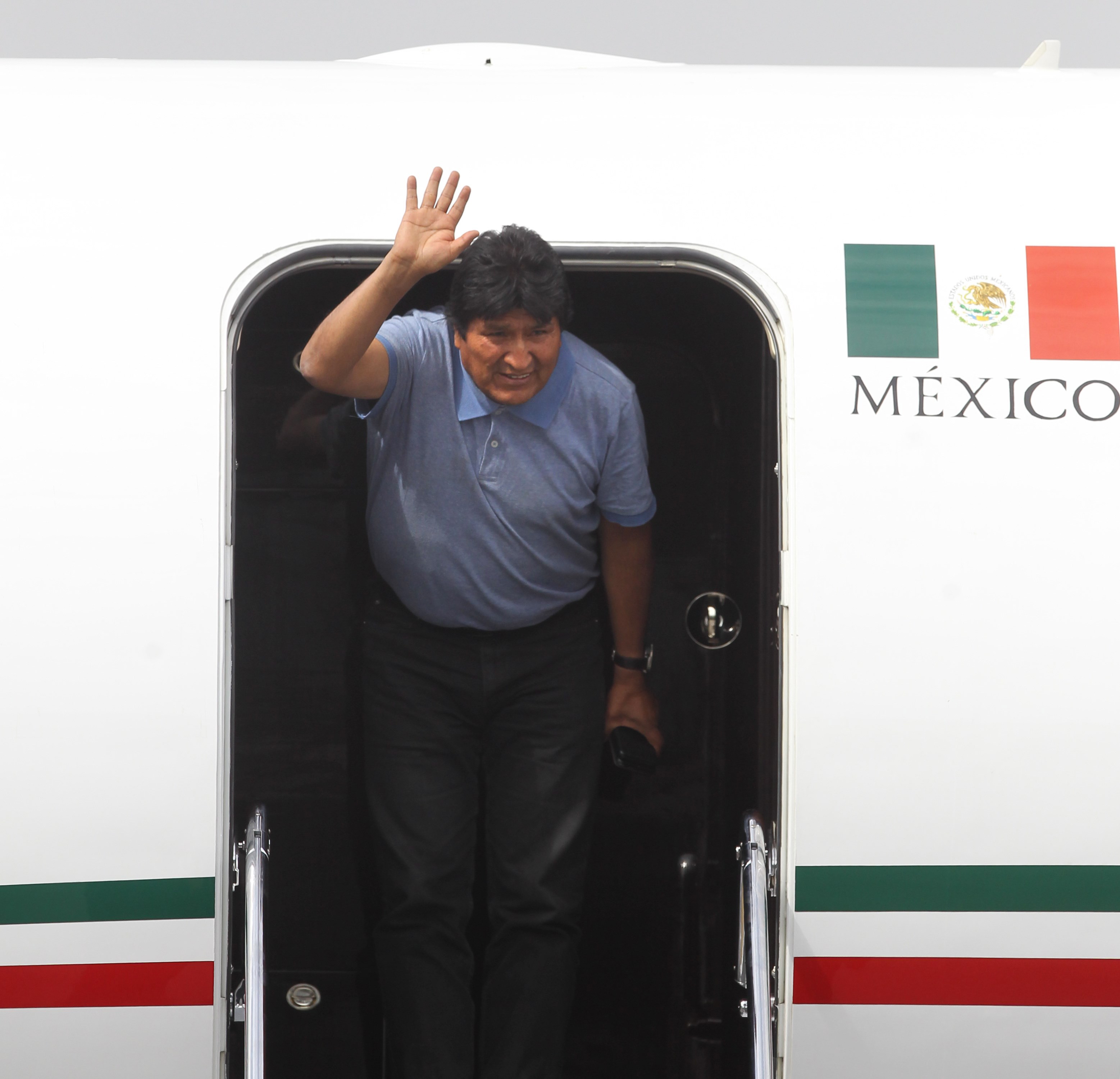 epa07991454 Former President of Bolivia Evo Morales arrives to the International Airport of Mexico City, Mexico, 12 November 2019. Evo Morales, who resigned on 10 November, arrived to Mexico to claim asylum onboard a plane of the Mexican Air Force that left Bolivia last night.  EPA/Mario Guzmán