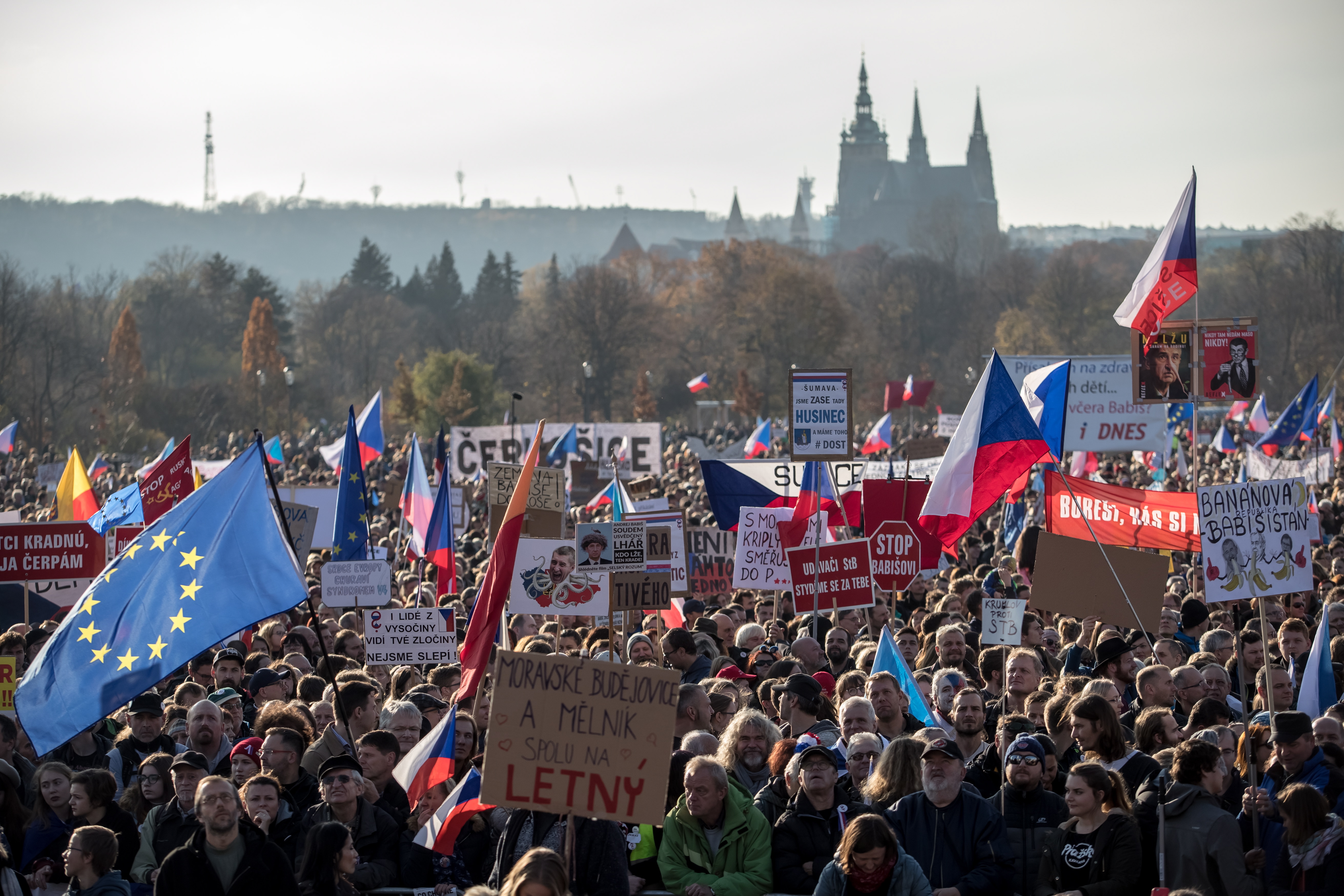 epa08001408 Demonstrators carry placards and flags as they gather to protest against Czech Prime Minister Andrej Babis, a day before the 30th anniversary of the so-called 'Velvet Revolution', at the Letna plain in Prague, Czech Republic, 16 November 2019. Tens of thousands of people were demanding the resignation of Babis due to alleged conflicts of interest involving his former Agrofert conglomerate he founded. According to chairman of the 'Million Moments for Democracy', Mikulas Minar, who organized the protest, Babis is abusing media and political power to profit his companies. The Czech Republic celebrates the 30th anniversary of their 'Velvet Revolution' commemorating the events of 17 November 1989, when waves of peaceful protests in both Czech and Slovak cities lasting ten days eventually brought down the Communist Government.  EPA/MARTIN DIVISEK