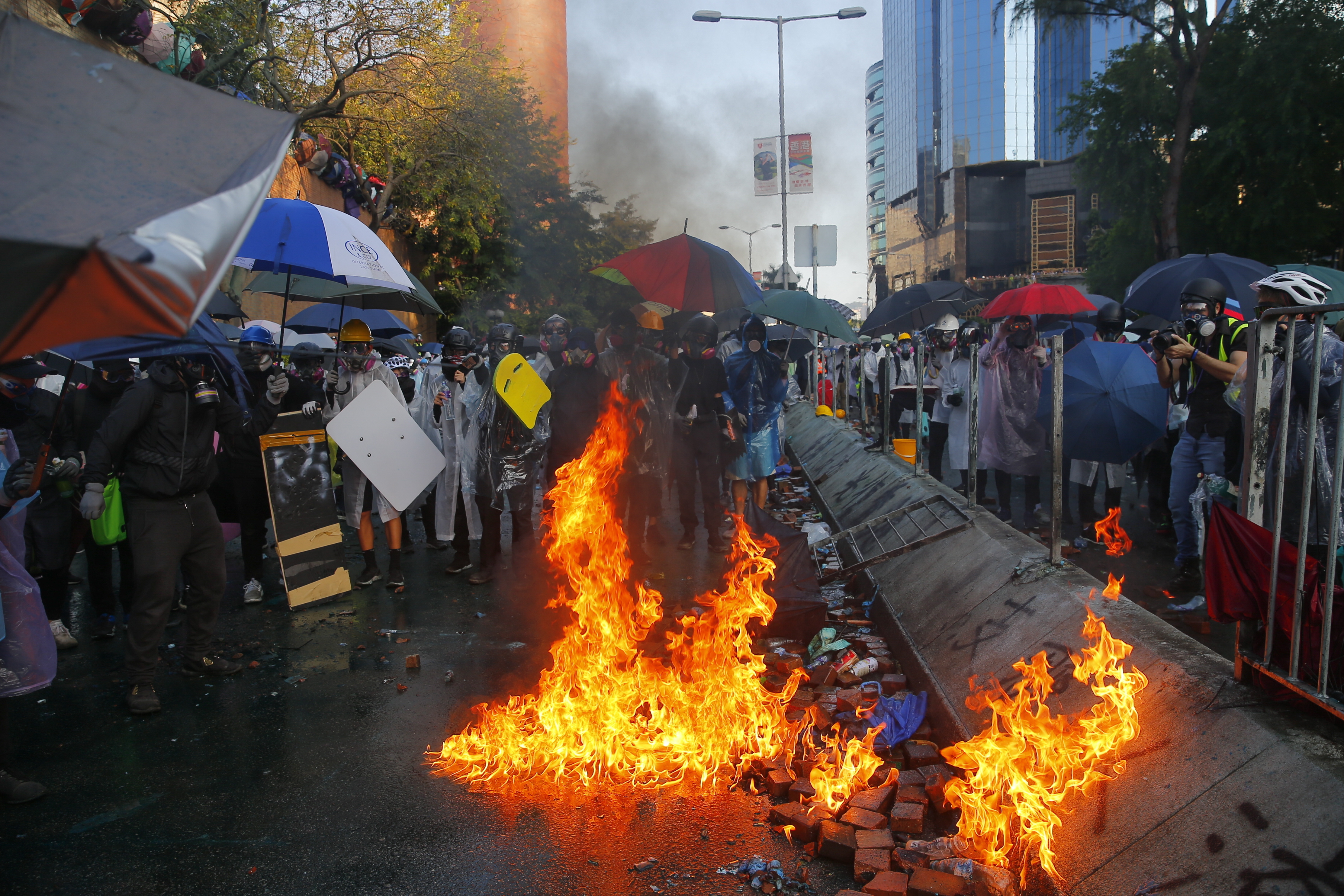 epa08003141 Pro-democracy protesters clash with police (not pictured) outside the Hong Kong Polytechnic University (PolyU), in Hong Kong, China, 17 November 2019. Hong Kong is in its sixth month of mass protests, which were originally triggered by a now withdrawn extradition bill and have since turned into a wider pro-democracy movement.  EPA/FAZRY ISMAIL