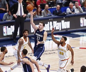 epaselect epa08013203 Dallas Mavericks player Luka Doncic (C) of Slovenia goes to the basket against the Golden State Warriors in the first half of their NBA basketball game at the American Airlines Center in Dallas, Texas, USA, 20 November 2019.  EPA/LARRY W. SMITH  SHUTTERSTOCK OUT