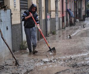 epa08019336 Locals clean up after floodings caused by bad weather in Genova, Italy, 23 November 2019.  EPA/LUCA ZENNARO