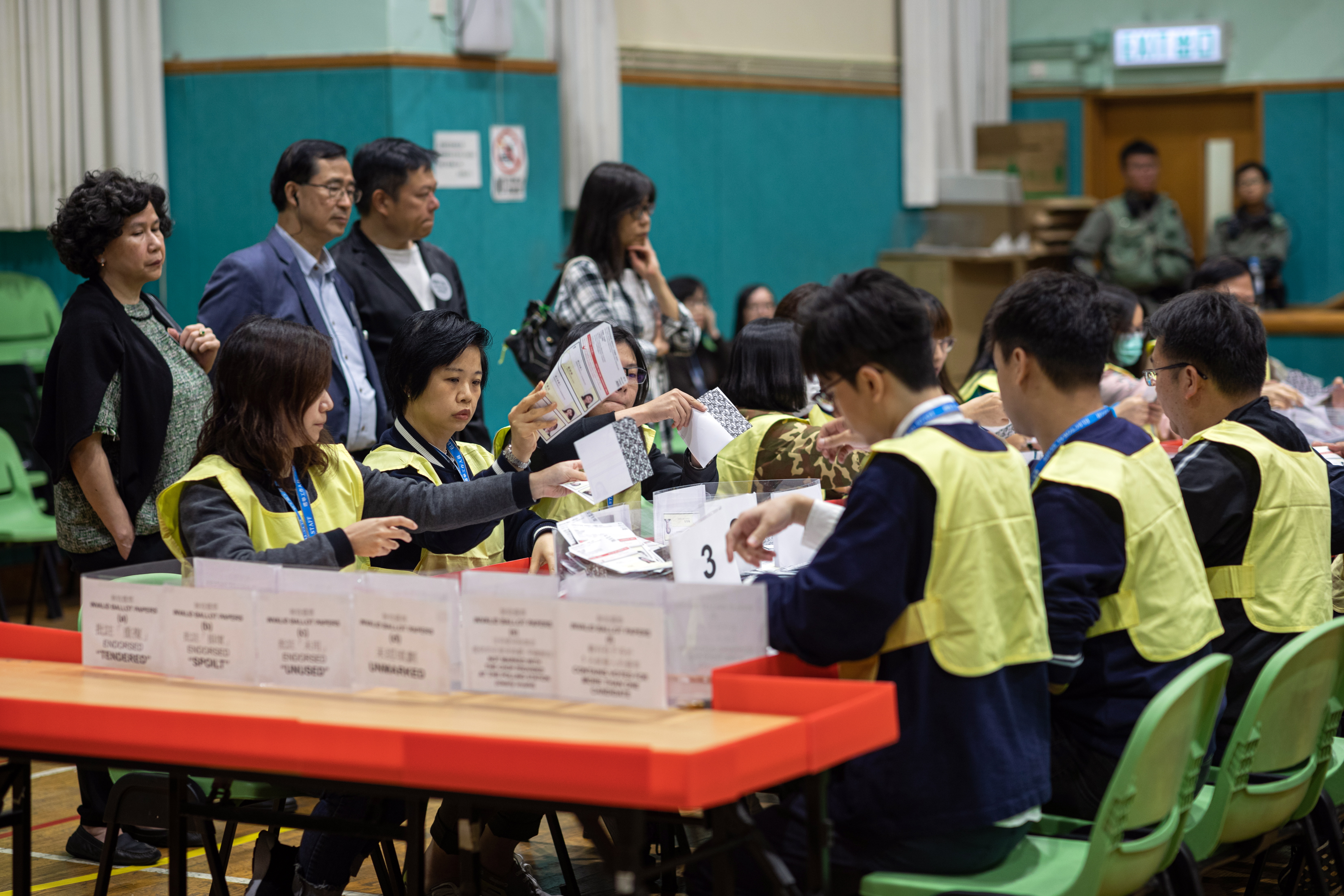 epa08022342 Staff from the Registration and Electoral Office count votes during the District Council Ordinary Election in Hong Kong, China, 24 November 2019. According to reports at least 2.8 million people voted on 24 November in the city's first election since the outbreak of widespread anti-government protests in June 2019.  EPA/JEROME FAVRE