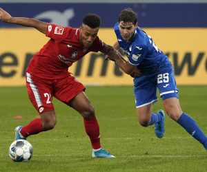 epa08022650 Robert Skov of Hoffenheim (R) in action against Karim Onisiwo of Mainz (L) during the German Bundesliga soccer match between TSG 1899 Hoffenheim and FSV Mainz 05 in Sinsheim, Germany, 24 November 2019.  EPA/RONALD WITTEK CONDITIONS - ATTENTION: The DFL regulations prohibit any use of photographs as image sequences and/or quasi-video.