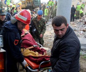 epa08028459 Rescue teams of fire fighters and police transport recovered bodies from the rubble of a building in Thumane, Albania, 27 November 2019. Albania was hit by a 6.4 magnitude earthquake on 26 November 2019, leaving until now over 30 people dead and 200 injured.  EPA/MALTON DIBRA