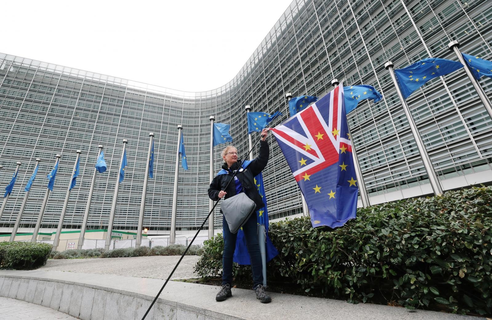 A woman holds a flag during a protest against Brexit outside the EU Commission headquarters in Brussels A woman holds a flag during a protest against Brexit outside the EU Commission headquarters in Brussels, Belgium October 9, 2019. REUTERS/Yves Herman YVES HERMAN