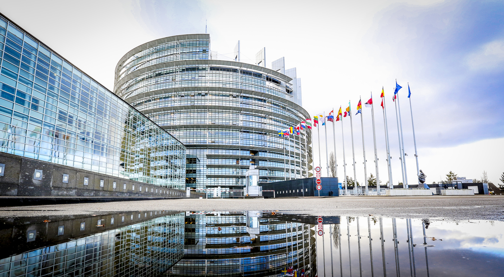 Building of the European parliament in Strasbourg - Reflection of Louise Weiss building in water puddle - Fall season