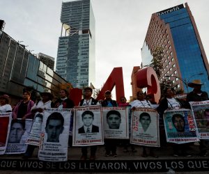 epa08028129 Parents of the 43 missing students from the Ayotzinapa Rural Teacher's College, accompanied by students and members of civil organizations, protest in Mexico City, Mexico, 26 November 2019. The protest comes on the eve of the fifth anniversary of the dissapearance of the students, who were allegedly detained by police and handed over to drug cartel gunmen, in the municipality of Iguala in the southern state of Guerrero.  EPA/JOSE MENDEZ