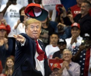 epaselect epa08028057 US President Donald J. Trump throws a 'Keep America Great' (KAG) cap at the crowd during a campaign rally at the BB&T Center in Sunrise, Florida, USA, 26 November 2019.  EPA/CRISTOBAL HERRERA