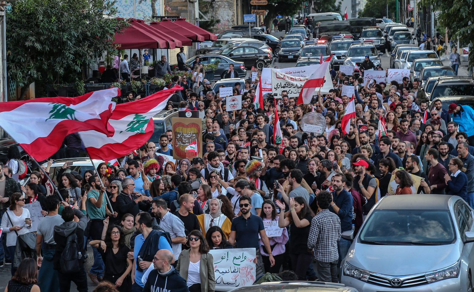 epa08037553 Protesters carry placards against sectarianism and shout slogans against the civil war during an anti-government protest as they march from Beirut Museum toward Martyr Square in Beirut, Lebanon, 01 December 2019. Protests in Lebanon are continuing since first erupted on 17 October, as protesters aim to apply pressure on the country's political leaders over what they view as a lack of progress following the prime minister's resignation on 29 October.  EPA/NABIL MOUNZER