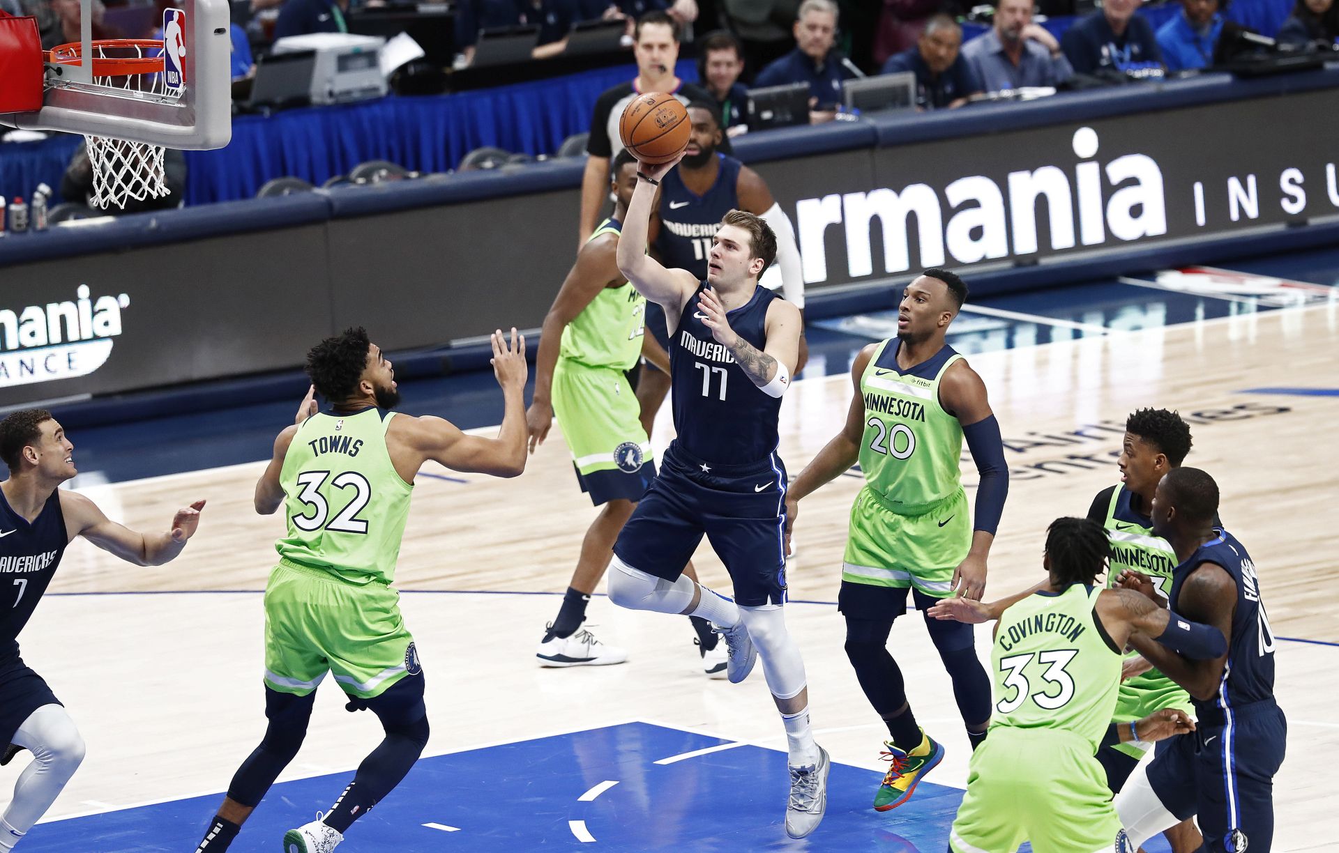 epa08045626 Minnesota Timberwolves player Karl-Anthony Towns (L) tries to block a shot against Dallas Mavericks player Luka Doncic (C) of Slovenia in the first half of their NBA basketball game at the American Airlines Center in Dallas, Texas, USA, 04 December 2019.  EPA/LARRY W. SMITH  SHUTTERSTOCK OUT
