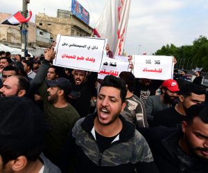 epa08049270 Supporters of Iraqi Shiite group Popular Crowd Forces and Iraqi Shiite Muslim spiritual leader Grands Ali al-Sistani carry their flag, as they take part in a demonstration at the Al Tahrir square in central Baghdad, Iraq, 06 December 2019. The demonstrators chanted slogans in support of the top Shi'ite cleric, Ali al-Sistani, and also waved flags of the Popular Mobilization and slogans against the United States and Israel.  EPA/MURTAJA LATEEF