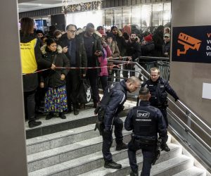 epa08056602 French railway police officers regulate the platform of a Paris to suburb train (RER) during a general strike action at Gare Du Nord train station in Paris, France, 09 December 2019. Unions representing railway and transport workers and many others in the public sector have called for a general strike and demonstration to protest against French government's reform of the pension system.  EPA/YOAN VALAT