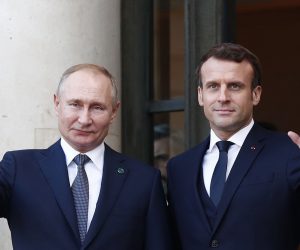 epa08057372 French President Emmanuel Macron (R) greets Russian President Vladimir Putin as he arrives to attend a summit on Ukraine at the Elysee Palace in Paris, France, 09 December 2019. German Chancellor Merkel, French President Macron, Ukrainian President Zelensky and Russian President Putin took part in the summit.  EPA/IAN LANGSDON