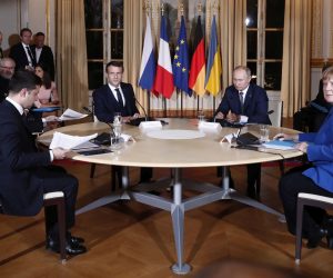 epa08057624 French President Emmanuel Macron (2-L), Russian President Vladimir Putin (2-R), Ukrainian President Volodymyr Zelensky (L) and German Chancellor Angela Merkel (R) attend a work session meeting during a summit on Ukraine at the Elysee Palace in Paris, France, 09 December 2019. German Chancellor Merkel, French President Macron, Ukrainian President Zelensky and Russian President Putin took part in the summit.  EPA/IAN LANGSDON / POOL