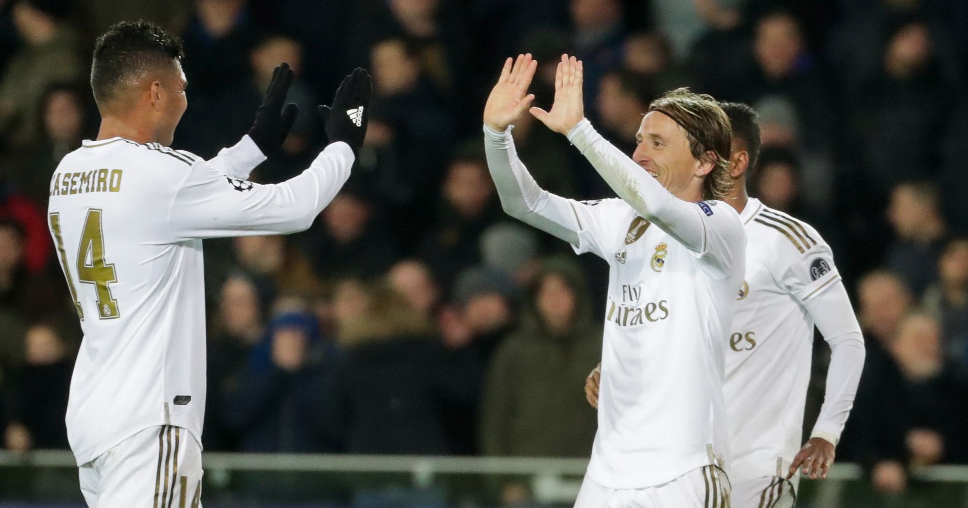 epa08063884 Real Madrid's Luka Modric celebrates with team mate Casemiro (L) after scoring a goal during the UEFA Champions League group A match between Club Brugge and Real Madrid in Bruges, Belgium, 11 December 2019.  EPA/STEPHANIE LECOCQ