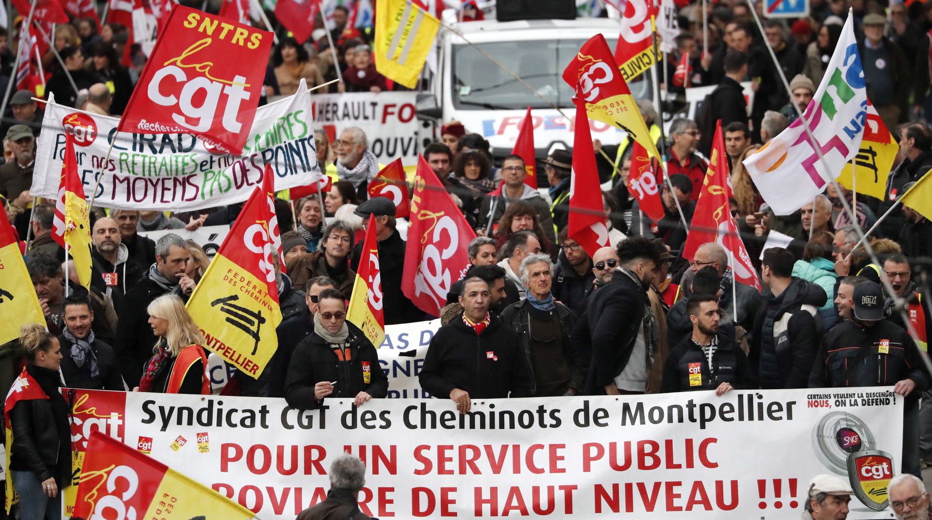 epa08065696 Members of the 'Confederation Generale du Travail' (CGT) trade union participate in a demonstration against pension reforms in Montpellier, France, 12 December 2019. Unions representing railway and transport workers and many others in the public sector have called for a general strike and demonstration to protest against French government's reform of the pension system.  EPA/GUILLAUME HORCAJUELO