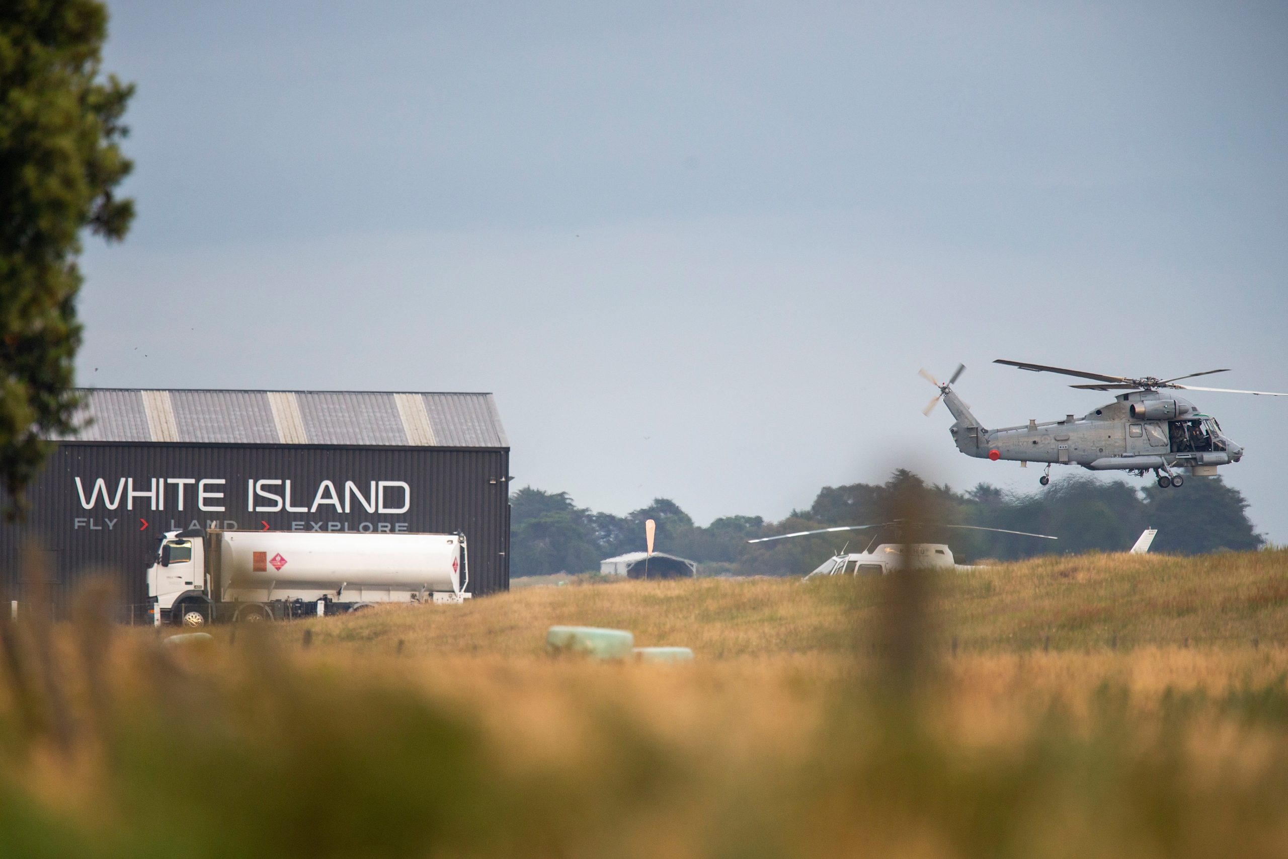 epa08066523 A military helicopter departs Whakatane airport during a recovery operation to retrieve the remaining bodies on White Island following its eruption in Whakatane, New Zealand, 13 December 2019.  EPA/DAVID ROWLAND AUSTRALIA AND NEW ZEALAND OUT