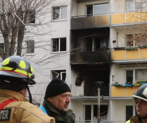 13 December 2019, Saxony-Anhalt, Blankenburg: Emergency personnel stand in front of the scorched facade of an apartment building where an explosion took place, killing one person and while at least 25 others were injured. Photo: Matthias Bein/dpa-Zentralbild/dpa
