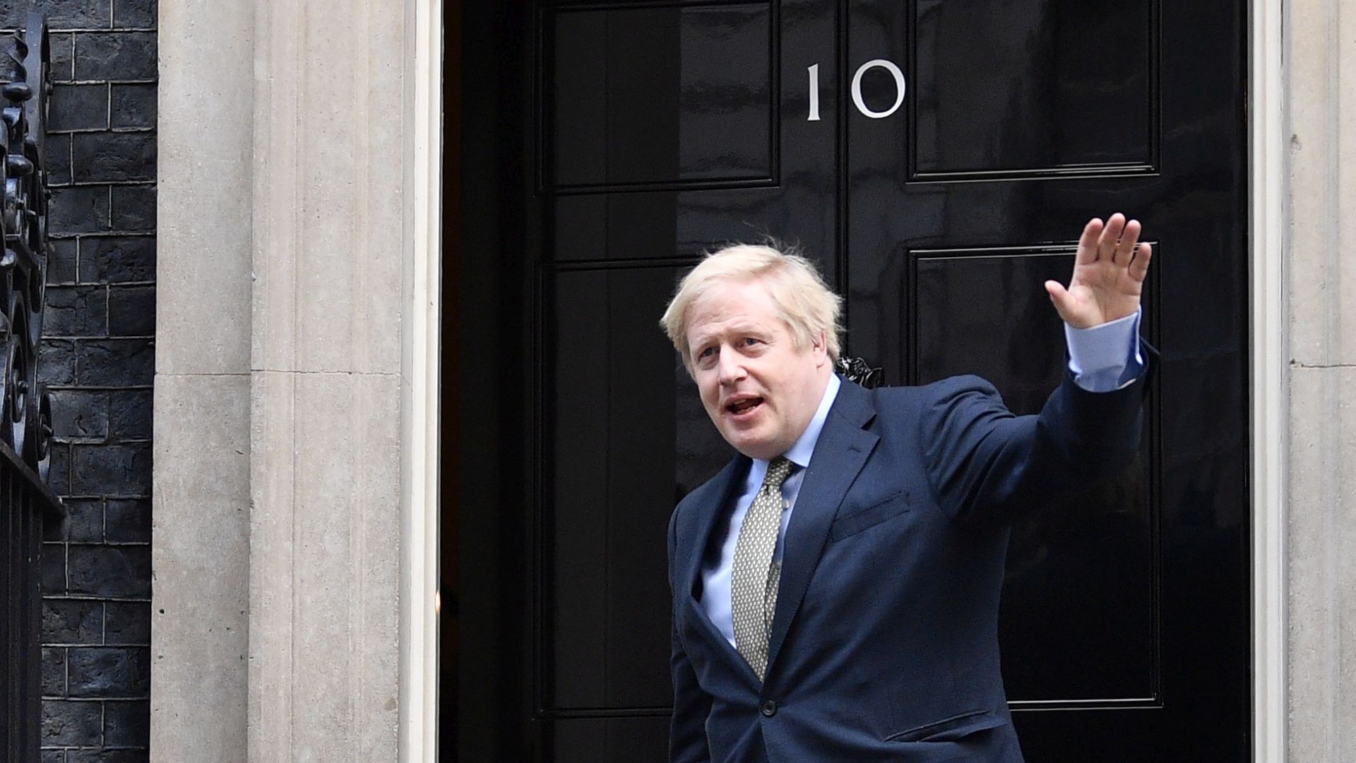 epa08068497 British Prime Minister Boris Johnson returns to 10 Downing Street after a meeting with the Queen in London, Britain, 13 December 2019. Britons went to the polls for a general election on 12 December 2019, which the Conservative Party led by Johnson has won with an overall majority.  EPA/NEIL HALL
