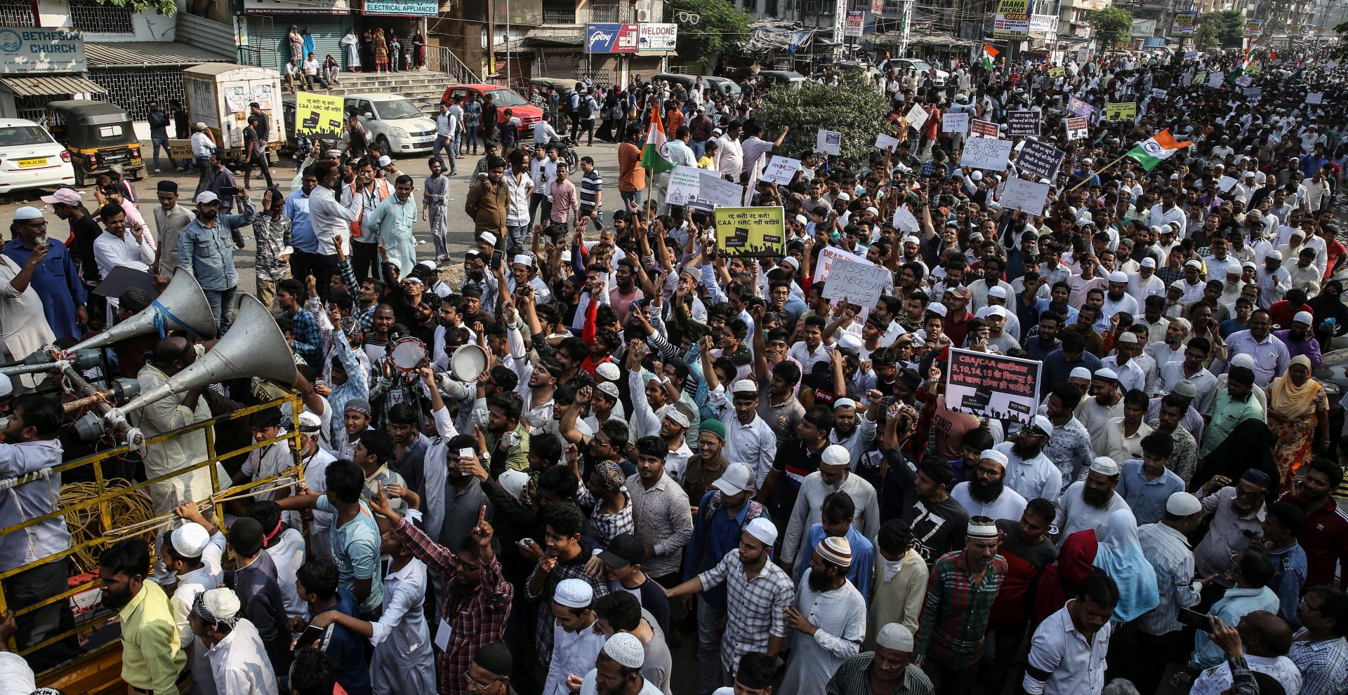 epa08079437 Indian Muslim protesters gather during a protest in solidarity with Jamia Millia Islamia University students and against the Citizenship Amendment Act (CAA) and National Register of Citizens (NRC), in Mumbra on the outskirts of Mumbai, India, 18 December 2019. According to news reports, four buses were set on fire during the demonstrations, with Delhi Police later allegedly entering the Jamia Millia Islamia University campus and detained some people believed to be violent protesters.  EPA/DIVYAKANT SOLANKI
