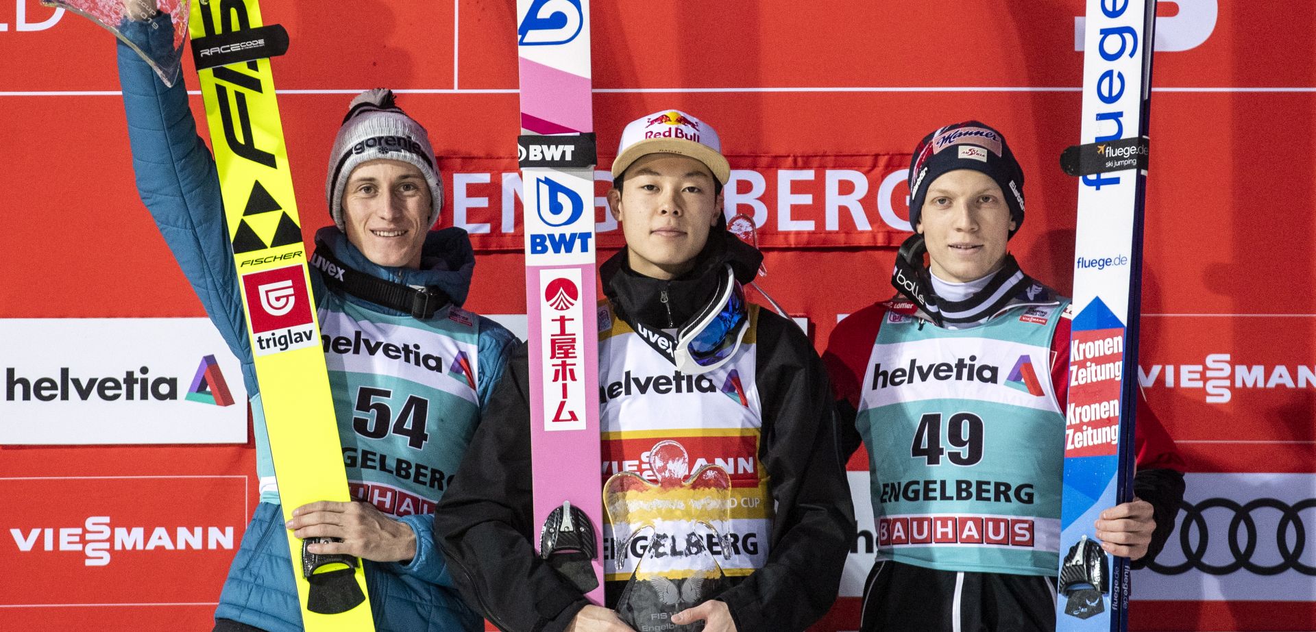 epa08086987 (L-R) Second-placed Peter Prevc of Slovenia, winner Ryoyu Kobayashi of Japan and third-placed Jan Hoerl of Austria celebrate on the podium after the men's ski jumping FIS World Cup event in Engelberg, Switzerland, 22 December 2019.  EPA/ALEXANDRA WEY