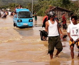 epa08089576 Motorists wade through water on a flooded road on Christmas day in the typhoon-hit city of Ormoc, Philippines, 25 December 2019. Typhoon Phanfone, (locally known as Ursula), made landfall in the Philippines with sustained winds of up to 150 kilometers per hour and caused cancellation at airports, seaports, and bus stations, affecting thousands of travelers on Christmas eve. Christmas is one of the busiest times of the year in the country, an archipelago made up of more than 7,000 islands with a population that is mostly Catholic.  EPA/ROBERT DEJON