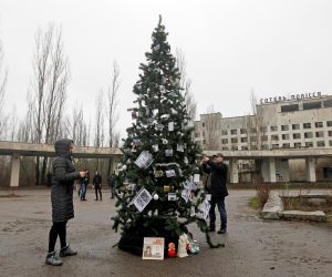epa08090044 A Christmas tree with photos of former residents is installed on a central square of the abandoned city of Pripyat, not far from the Chernobyl nuclear power station, Ukraine, 25 December 2019. For the first time in 33 years, the Christmas tree was set up in Pripyat at the Chornobyl Exclusion Zone. Eighteen former residents of Pripyat who had not been in their hometown for many years decorated the Cristmass tree with their family photos taken in Pripyat when the city was not yet evicted. In the early hours of 26 April 1986 the Unit 4 reactor at the Chernobyl power station blew apart. Facing nuclear disaster on unprecedented scale, Soviet authorities tried to contain the situation by sending thousands of ill-equipped men into a radioactive maelstrom. The explosion of Unit 4 of the Chernobyl nuclear power plant is still regarded the biggest accident in the history of nuclear power generation.  EPA/STEPAN FRANKO