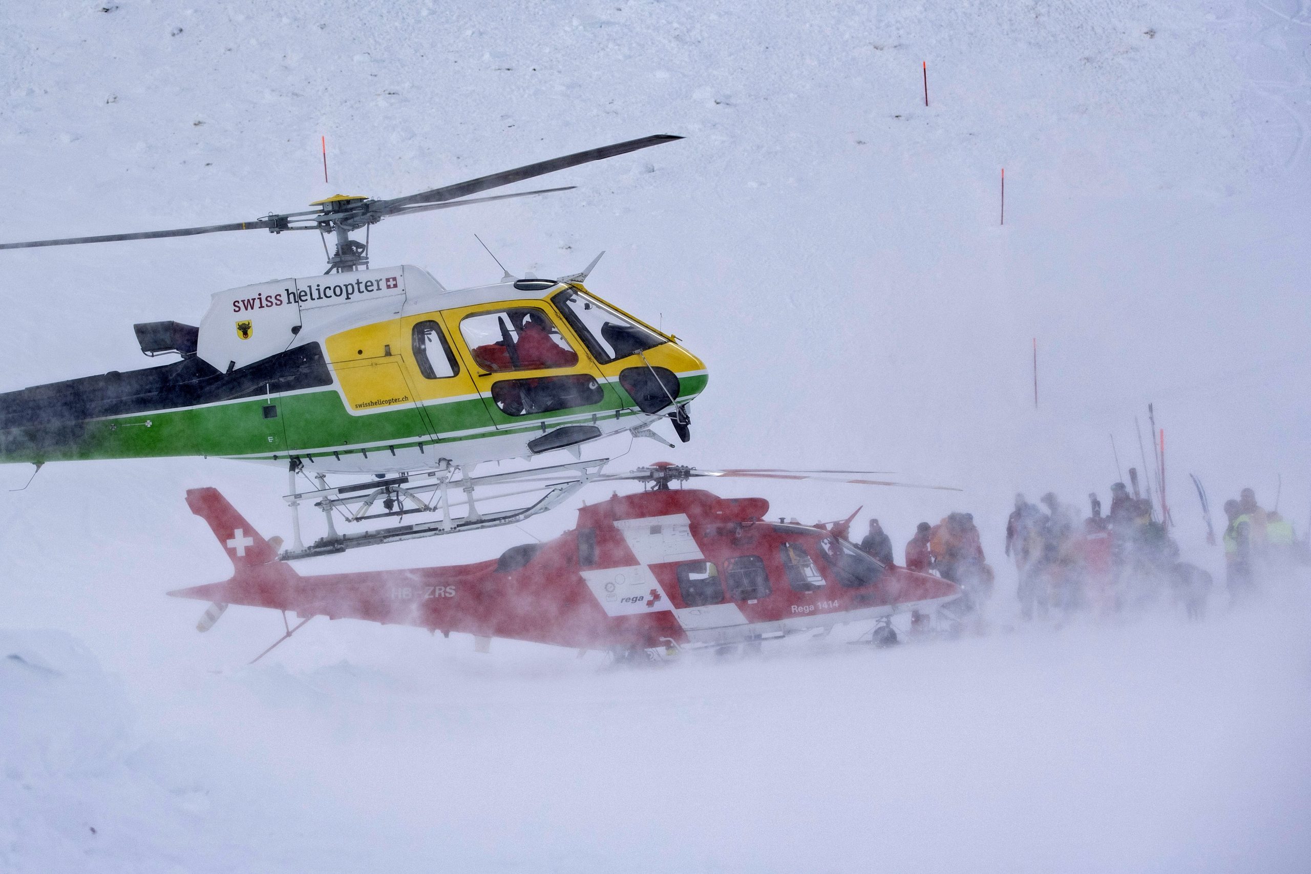 epa08090919 Rescue forces and helicopters search for missing persons after an avalanche swept down a ski piste in the central town of Andermatt in canton Uri, Switzerland, Switzerland, 26 December 2019. Six people have been rescued, two of them with minor injuries but cantonal authorities fear that several other people may be buried. An extensive rescue operation is underway.  EPA/Urs Flueeler