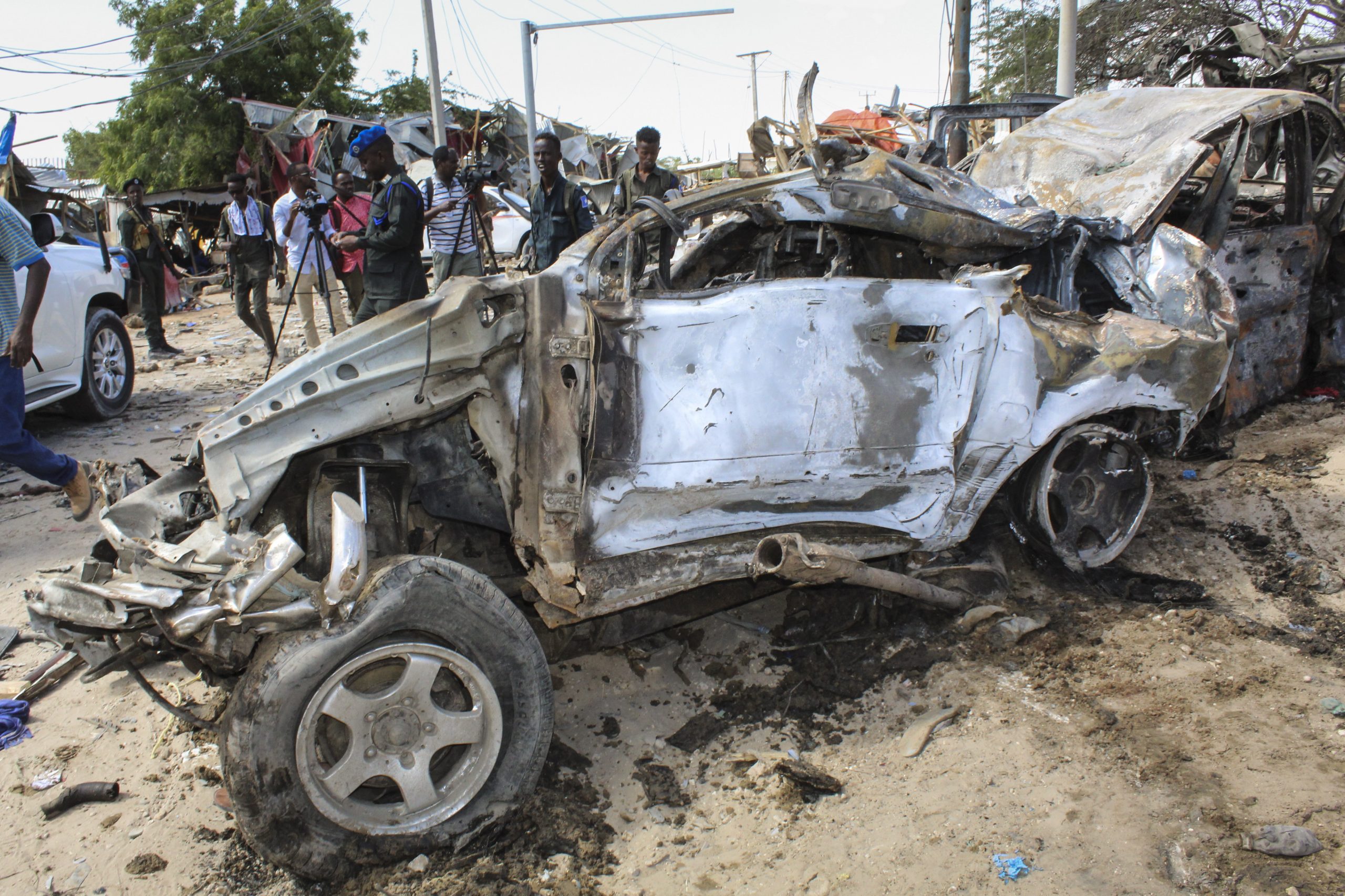epa08092359 A view of the wreckage of a vehicle at the scene of a large explosion near a check point in Mogadishu, Somalia, 28 December 2019. A source at a hospital said that at least 25 people have been killed in what is believed to have been a car bombing. The explosion rocked an area near the junction called Ex-Control Afgoye, in a southwestern suburb of the capital Mogadishu.  EPA/SAID YUSUF WARSAME