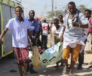 epa08092427 An injured person is carried away from the scene of a large explosion near a check point in Mogadishu, Somalia, 28 December 2019. A source at a hospital said that the death toll has risen to at least 76 in what is believed to have been a car bombing. The explosion rocked an area near the junction called Ex-Control Afgoye, in a southwestern suburb of the capital Mogadishu.  EPA/SAID YUSUF WARSAME