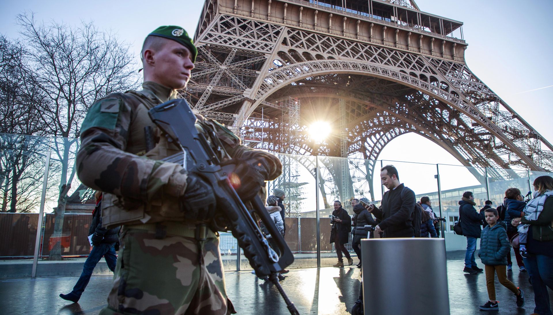 epa08094804 A French soldier from the 'Sentinelle military Operation' stands guard as Interior Minister Castaner  (unseen) visits the security forces securing the Eiffel Tower  to discuss New Year holiday security measures in Paris, France, 30 December 2019.  EPA/CHRISTOPHE PETIT TESSON
