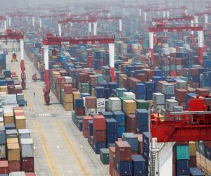 FILE PHOTO: A man walks in a shipping container area at Yangshan Port of Shanghai FILE PHOTO: A man walks in a shipping container area at Yangshan Port of Shanghai May 11, 2012. REUTERS/Aly Song/File Photo Aly Song