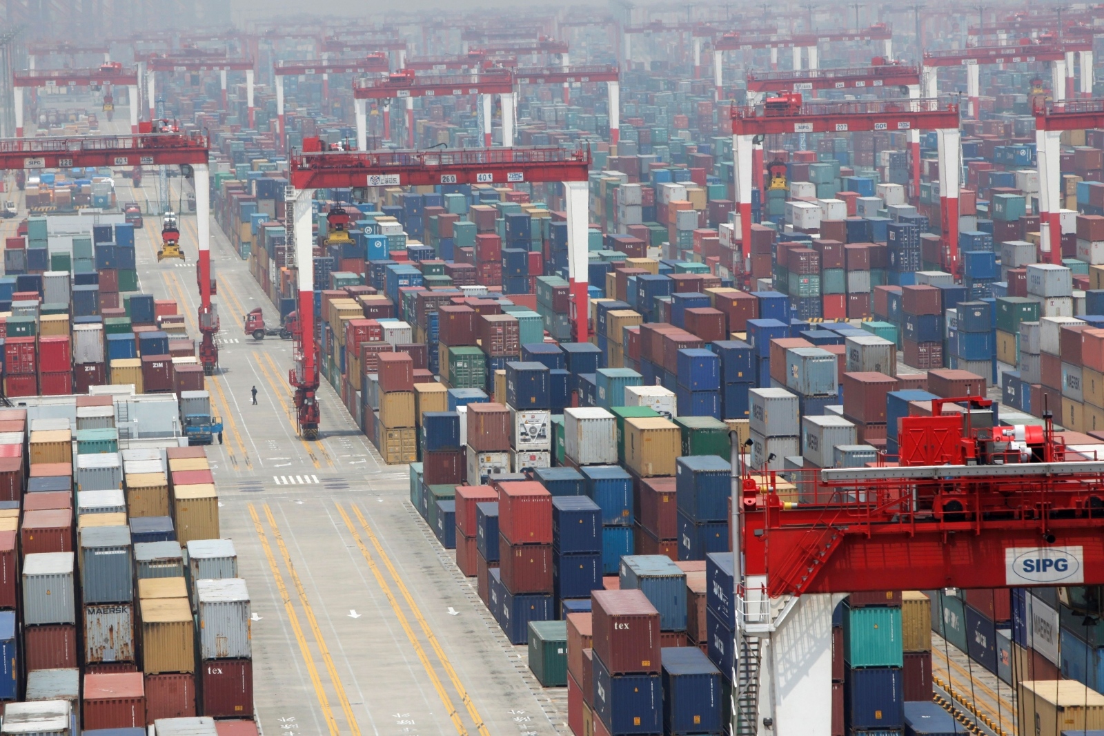 FILE PHOTO: A man walks in a shipping container area at Yangshan Port of Shanghai FILE PHOTO: A man walks in a shipping container area at Yangshan Port of Shanghai May 11, 2012. REUTERS/Aly Song/File Photo Aly Song