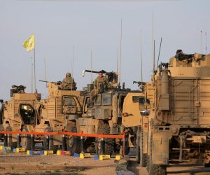 FILE PHOTO: American soldiers stand near military trucks, at al-Omar oil field in Deir Al Zor FILE PHOTO: American soldiers stand near military trucks, at al-Omar oil field in Deir Al Zor, Syria March 23, 2019. REUTERS/Rodi Said/File Photo Rodi Said
