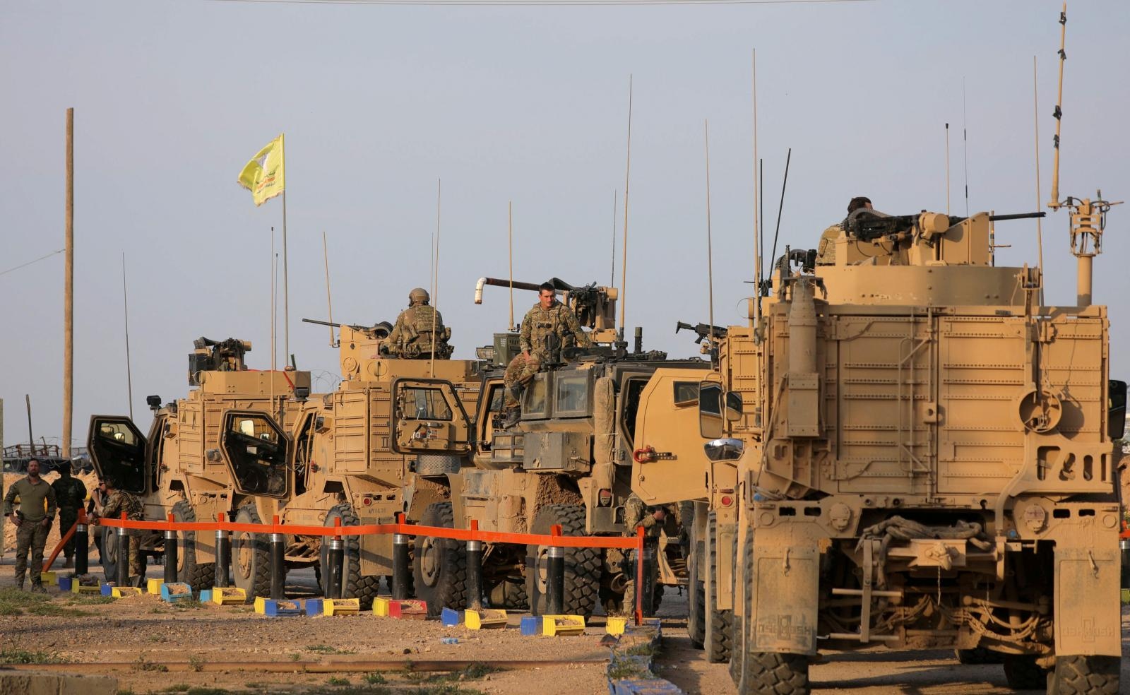 FILE PHOTO: American soldiers stand near military trucks, at al-Omar oil field in Deir Al Zor FILE PHOTO: American soldiers stand near military trucks, at al-Omar oil field in Deir Al Zor, Syria March 23, 2019. REUTERS/Rodi Said/File Photo Rodi Said