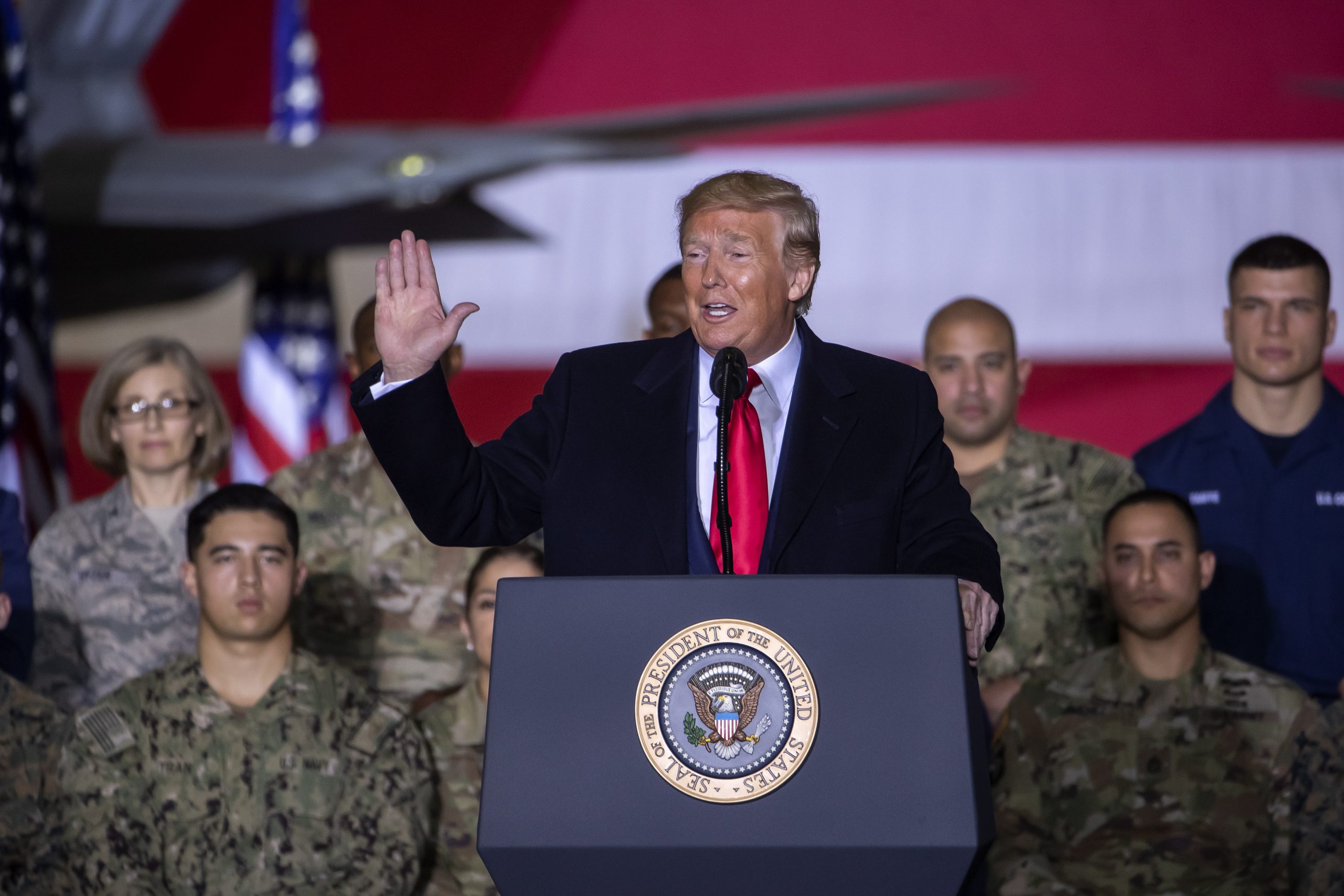 epa08084324 US President Donald J. Trump (C) speaks on stage during the signing ceremony for the National Defense Authorization Act for Fiscal Year 2020 inside Hangar Six at Joint Base Andrews in Suitland, Maryland, USA, 20 December 2019. The 738 billion US dollar military funding bill includes the creation of the Space Force.  EPA/ERIK S. LESSER