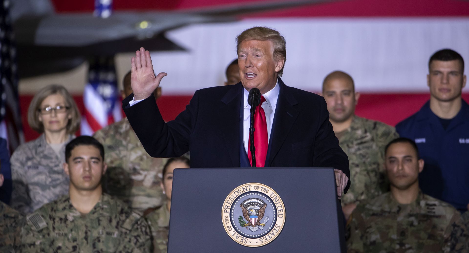 epa08084324 US President Donald J. Trump (C) speaks on stage during the signing ceremony for the National Defense Authorization Act for Fiscal Year 2020 inside Hangar Six at Joint Base Andrews in Suitland, Maryland, USA, 20 December 2019. The 738 billion US dollar military funding bill includes the creation of the Space Force.  EPA/ERIK S. LESSER