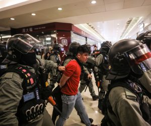 epa08092791 A riot police officer detains a protester after using pepper spray on him during a protest in Sheung Shui in Hong Kong, China, 28 December 2019. Protests flared up in malls in the outlying districts on Hong Kong as the new year approaches. Hong Kong has entered its seventh month of mass protests, which were originally triggered by a now withdrawn extradition bill, and have since turned into a wider pro-democracy movement.  EPA/VIVEK PRAKASH