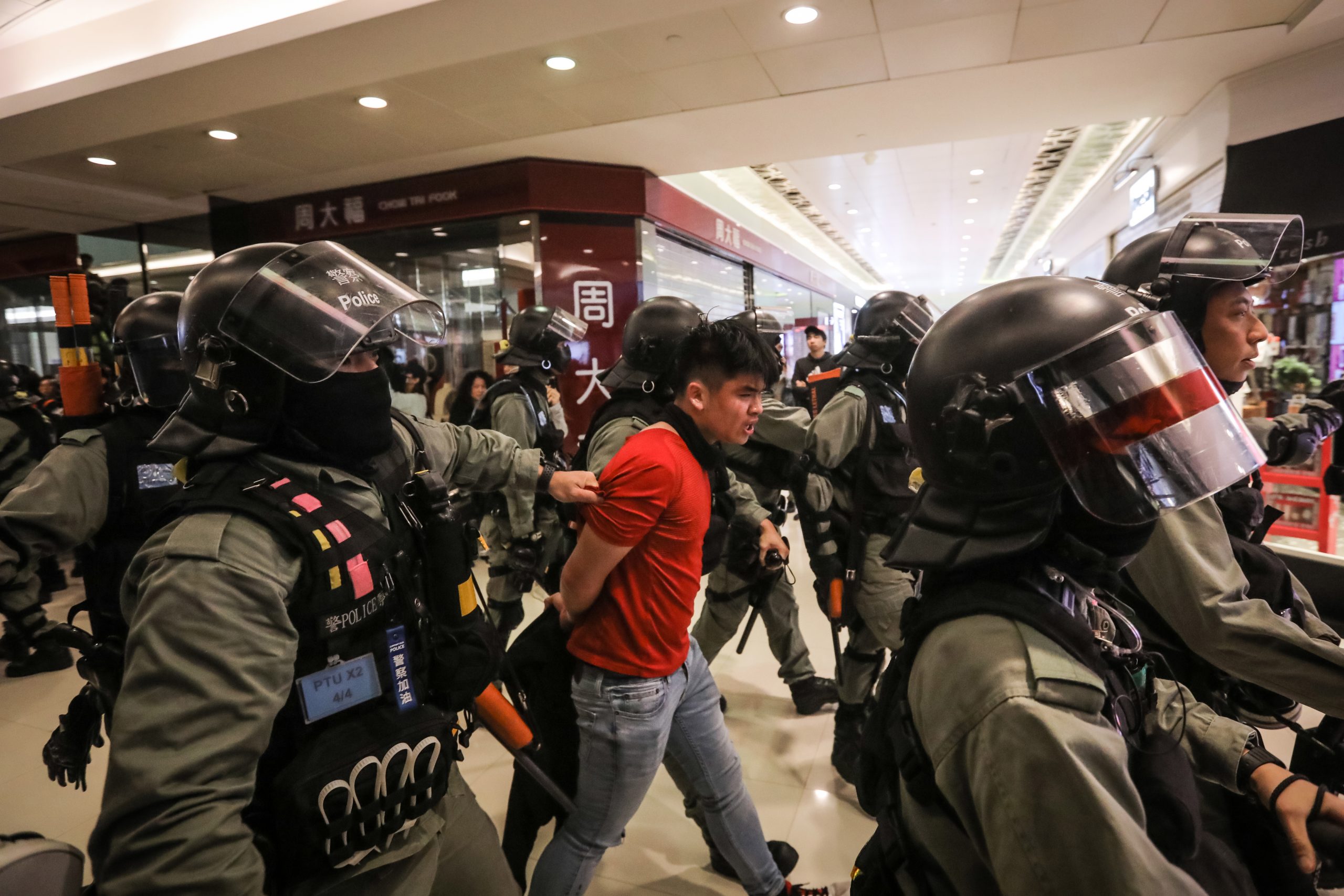 epa08092791 A riot police officer detains a protester after using pepper spray on him during a protest in Sheung Shui in Hong Kong, China, 28 December 2019. Protests flared up in malls in the outlying districts on Hong Kong as the new year approaches. Hong Kong has entered its seventh month of mass protests, which were originally triggered by a now withdrawn extradition bill, and have since turned into a wider pro-democracy movement.  EPA/VIVEK PRAKASH