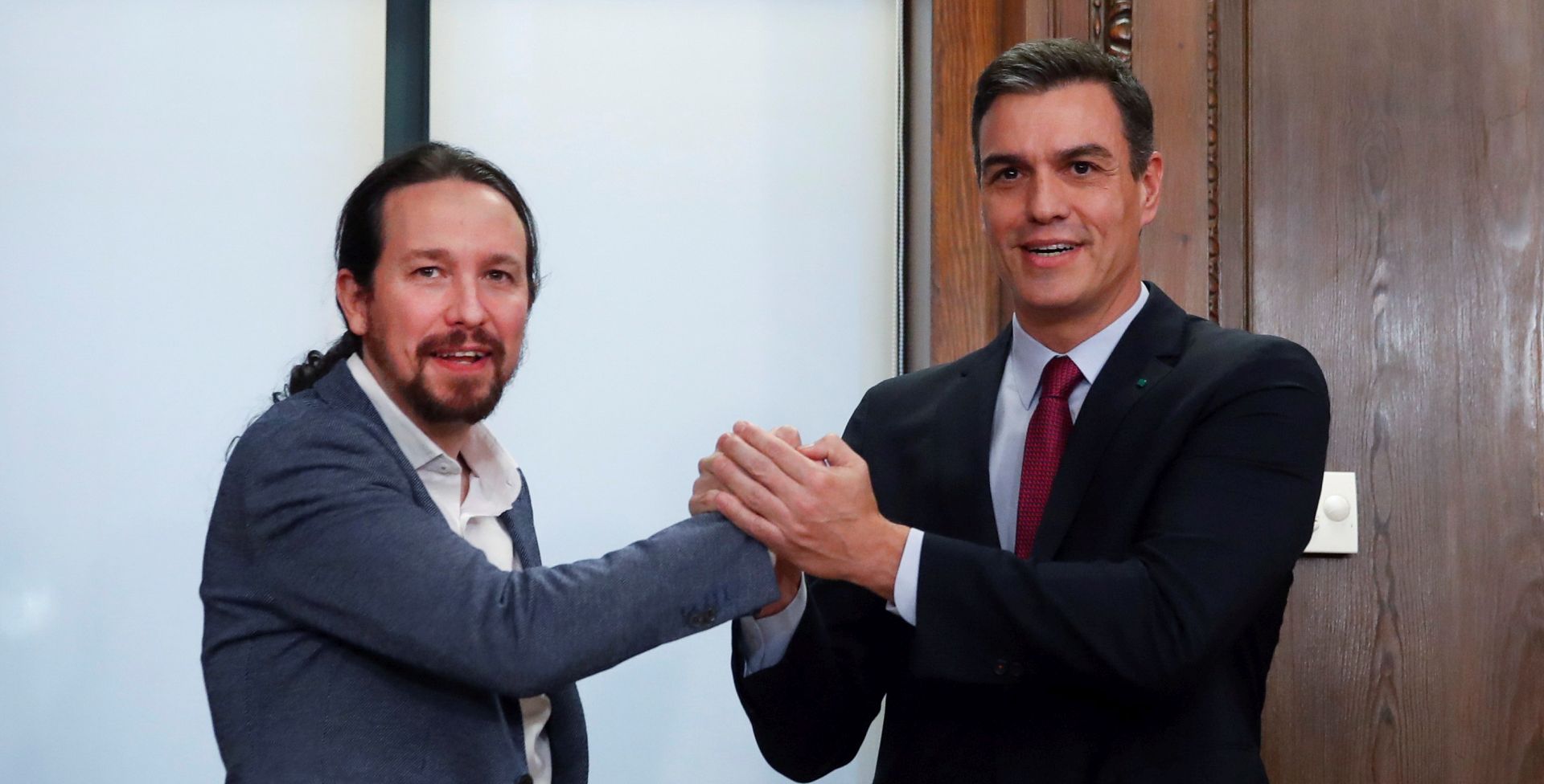 epa08095094 Acting Spanish Prime Minister, Pedro Sanchez (R) and Spanish Podemos Party's leader Pablo Iglesias (L) pose after a meeting to sign a preliminary policy agreement at the Spanish Lower House in Madrid, Spain, 30 December 2019. Spanish Socialist Party and Podemos Party have reached a deal to form a coalition government that is still pending the support of Catalan pro-independence party Esquerra Repulicana (ERC) to abstain in the voting and thus invest Sanchez.  EPA/JuanJo Martin