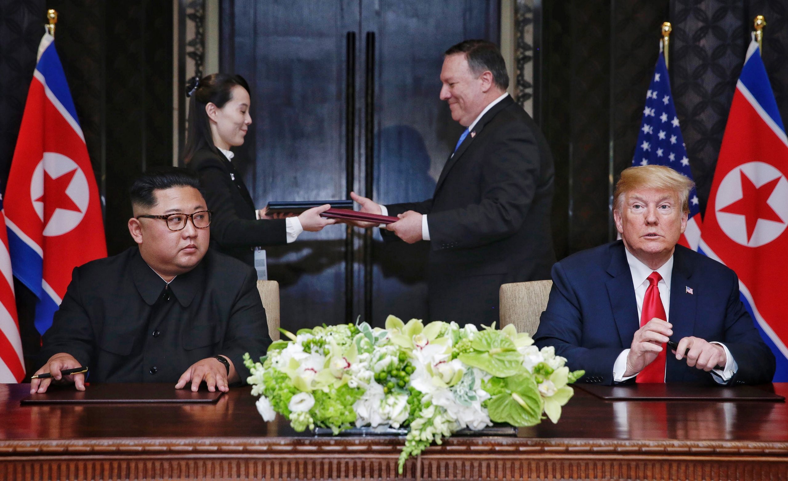 epa08095886 PICTURES OF THE DECADE 

A document being exchanged between US Secretary of State Mike Pompeo (2-R) and North Korean leader's sister Kim Yo Jong (2-L) moments after it was signed by President Donald J. Trump (R) and North Korean Chairmain Kim Jong-un (L) during their first meeting, at the Capella Hotel on Sentosa Island, Singapore, 12 June 2018.  EPA/KEVIN LIM / THE STRAITS TIMES   EDITORIAL USE ONLY