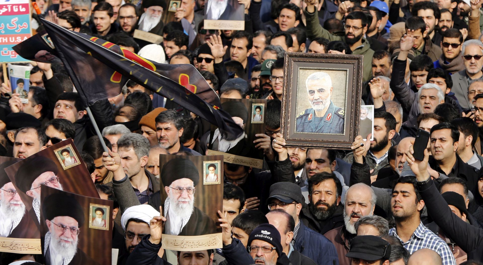 epa08099832 Iranians holding pictures of Supreme Leader Ali Khamenei and of Iranian Revolutionary Guards Corps (IRGC) Lieutenant general and commander of the Quds Force Qasem Soleimani take to the streets during an anti-US demonstration to condemn the killing of Soleimani, after Friday prayers in Tehran, Iran, 03 January 2020. The Pentagon announced that Iran's Quds Force leader Qasem Soleimani and Iraqi militia commander Abu Mahdi al-Muhandis were killed on 03 January 2020 following a US airstrike at Baghdad's international airport. The attack comes amid escalating tensions between Tehran and Washington.  EPA/ABEDIN TAHERKENAREH