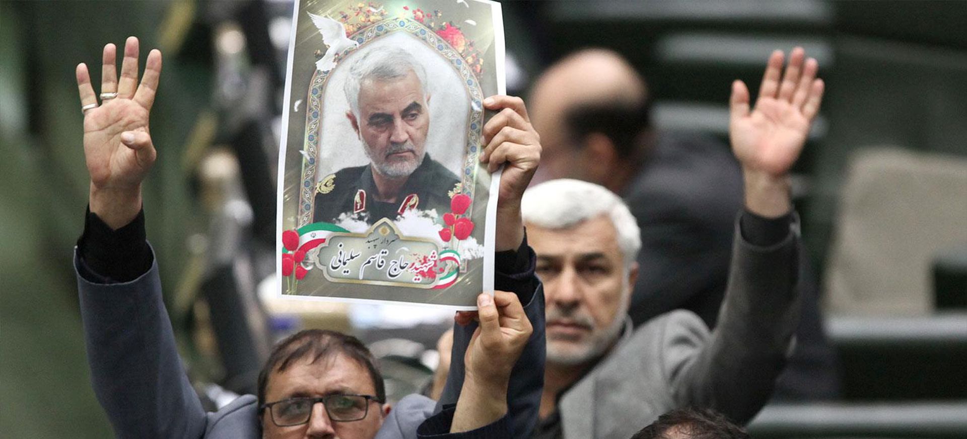 epa08109624 A handout photo made available by the Iranian Parliament officials news agency (ICANA) shows, Iranian lawmakers holding pictures of slain Iran's Quds Force leader Qasem Soleimani as they chant 'death to America', during a parliament session in Tehran, Iran, 07 January 2020. Media reported that Iranian Parliament vote on 07 January 2020, to put the members of the US department of defence 'Pentagon' and their relatives to the terrorist group list. Soleimani was killed in a targeted US airstrike on 03 January 2020 in Baghdad, Iraq.  EPA/ICANA HANDOUT  HANDOUT EDITORIAL USE ONLY/NO SALES