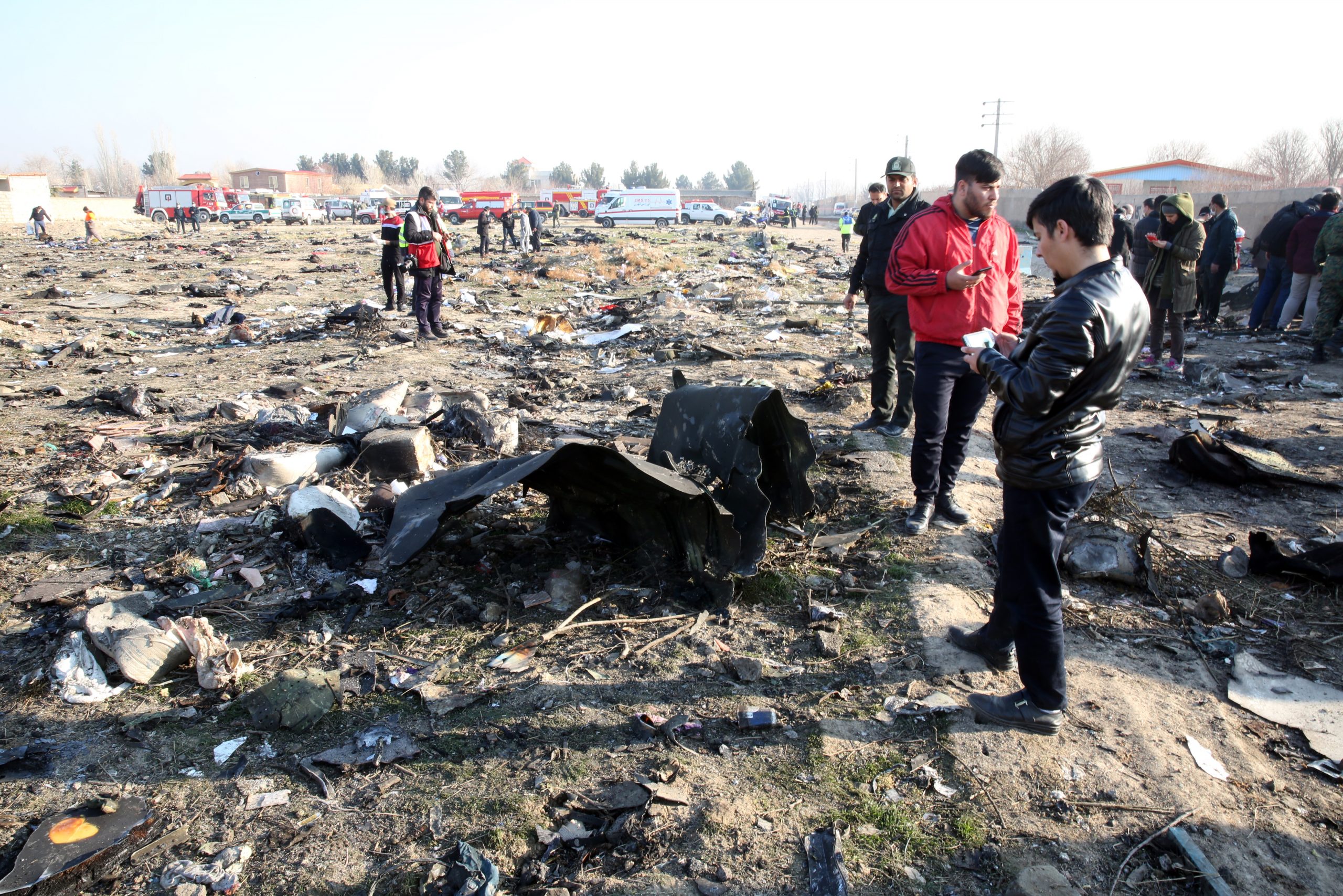 epa08111562 Emergency services personnel work amidst the wreckage after an Ukraine International Airlines Boeing 737-800 carrying 176 people crashed near Imam Khomeini Airport in Tehran, killing everyone on board; in Shahriar, Iran, 08 January 2020.  EPA/ABEDIN TAHERKENAREH
