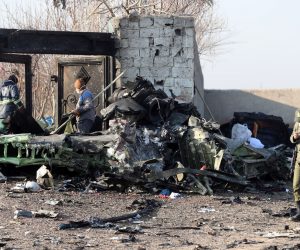 epa08111588 Iranian soldiers stand guard next to the wreckage after an Ukraine International Airlines Boeing 737-800 carrying 176 people crashed near Imam Khomeini Airport in Tehran, killing everyone on board; in Shahriar, Iran, 08 January 2020.  EPA/ABEDIN TAHERKENAREH