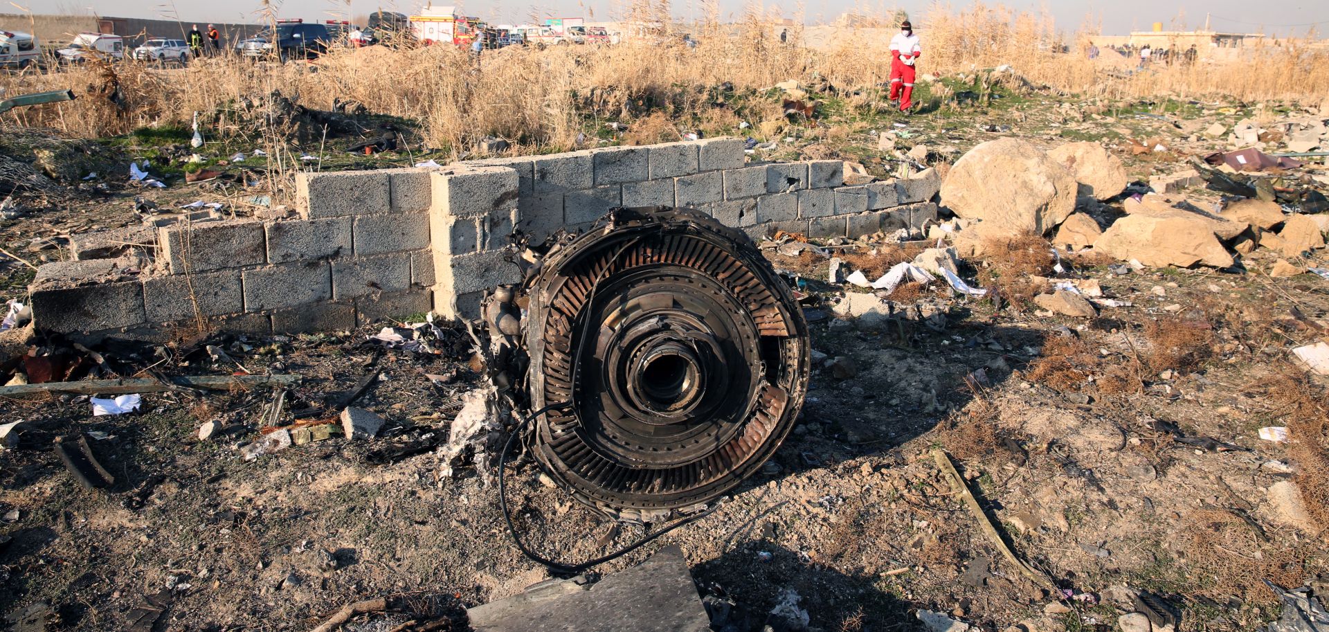 epa08111783 One of the engine of the plane lies among the wreckage after an Ukraine International Airlines Boeing 737-800 carrying 176 people crashed near Imam Khomeini Airport in Tehran, killing everyone on board, in Shahriar, Iran, 08 January 2020.  EPA/ABEDIN TAHERKENAREH
