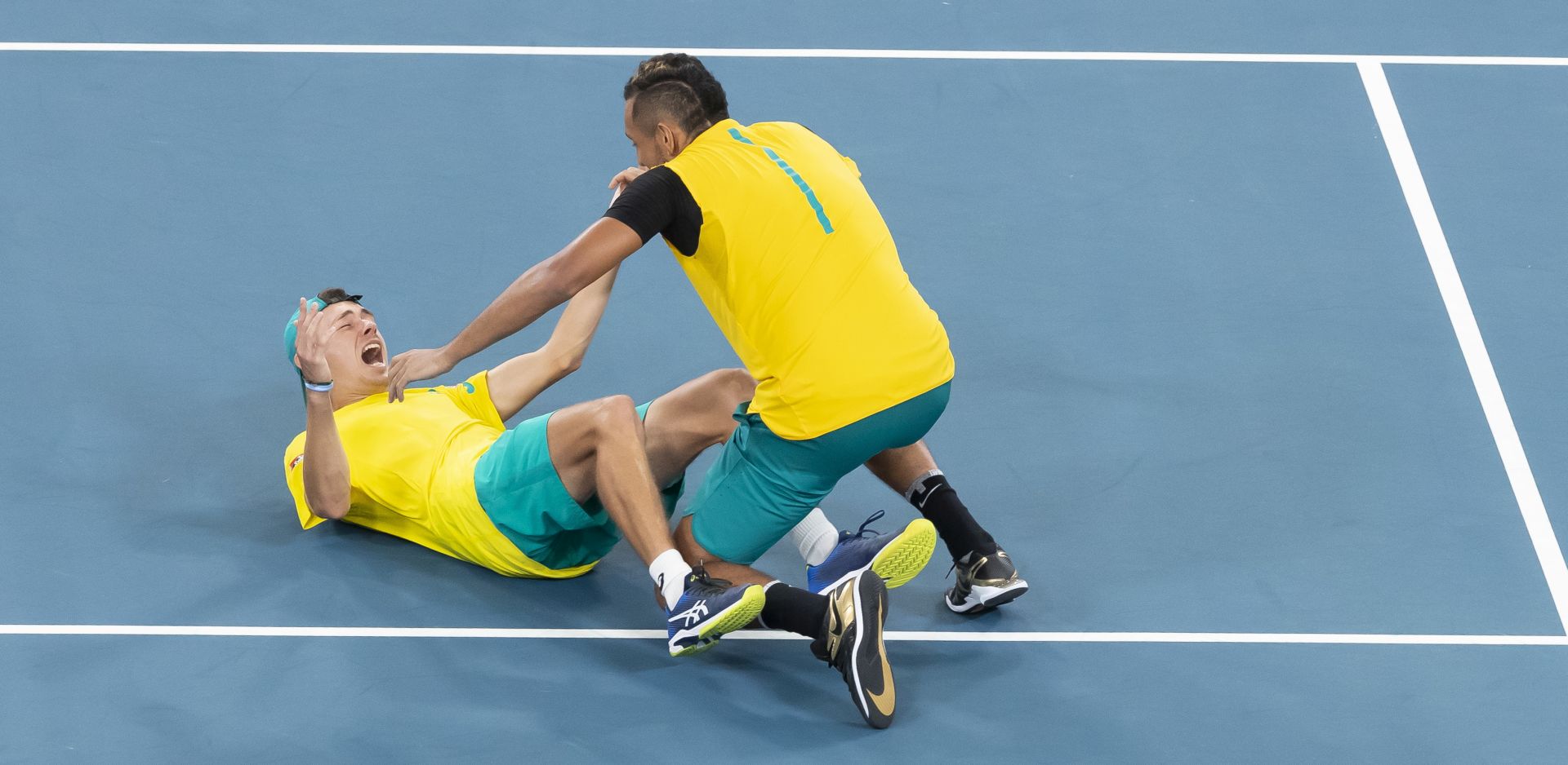 epa08113710 Alex De Minaur (L) and Nick Kyrgios (R) of Australia celebrate winning the doubles match against Jamie Murray and Joe Salisbury of Great Britain during the quarter final on day seven of the ATP Cup tennis tournament at Ken Rosewall Arena in Sydney, Australia, 09 January 2020.  EPA/CRAIG GOLDING EDITORIAL USE ONLY AUSTRALIA AND NEW ZEALAND OUT