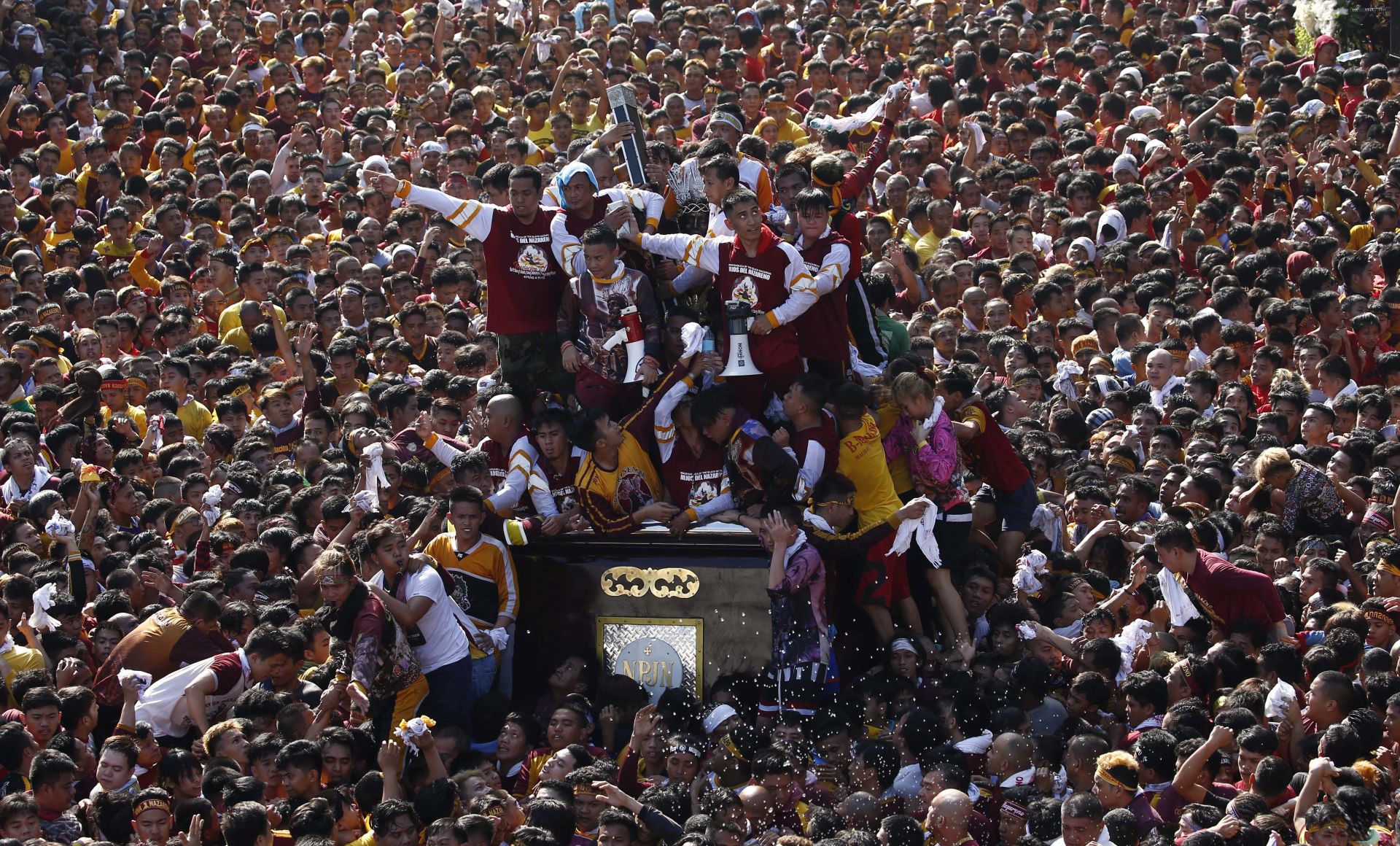 epa08113511 The Black Nazarene is taken on a procession as Catholic devotees flock around to mark its feast day in Manila, Philippines, 09 January 2020. The feast of the Black Nazarene is one of the most celebrated religious events in the predominantly Catholic Philippines, where more than 80 percent of the population professes the faith. The wooden statue, crowned with thorns and bearing a cross, is believed to have been brought from Mexico to Manila in 1606 by Spanish missionaries. The ship that carried it caught fire, but the charred statue survived and was named the Black Nazarene.  EPA/ROLEX DELA PENA